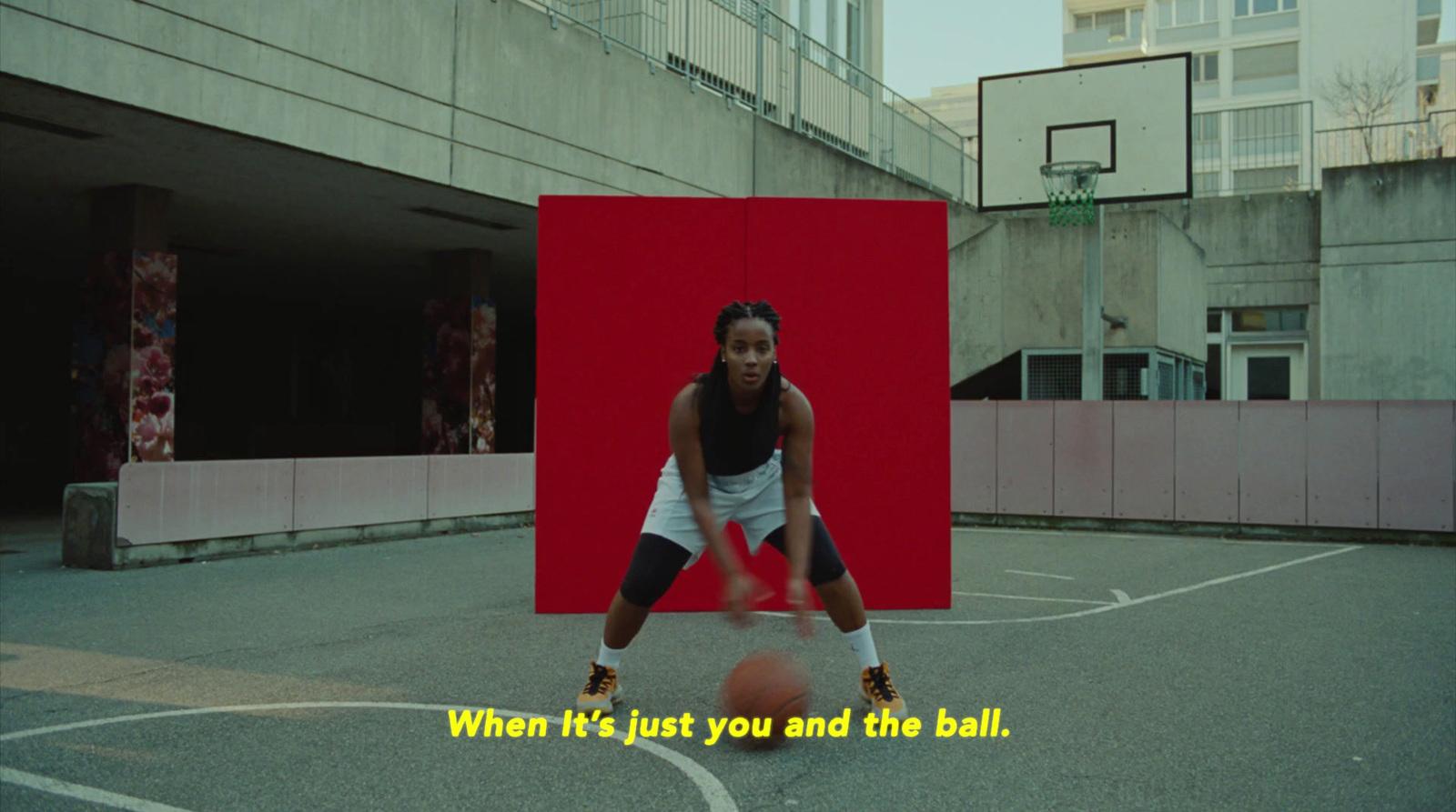 a woman is playing basketball on a basketball court