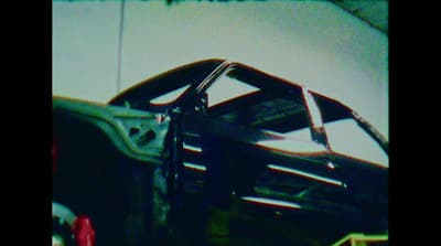 a black and white photo of a car in a garage