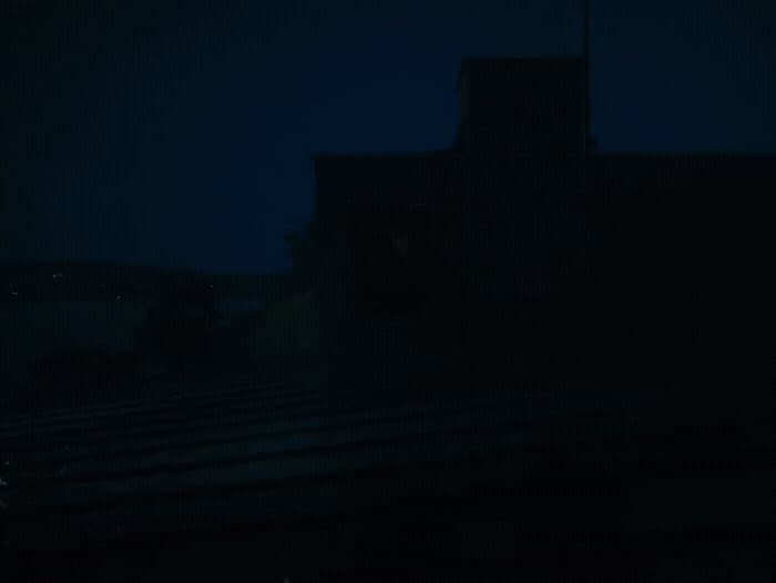 a dark picture of a building at night