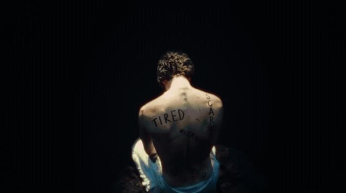 a man with a tattoo on his back