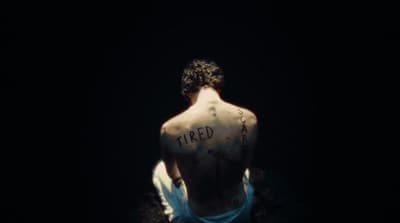 a man with a tattoo on his back