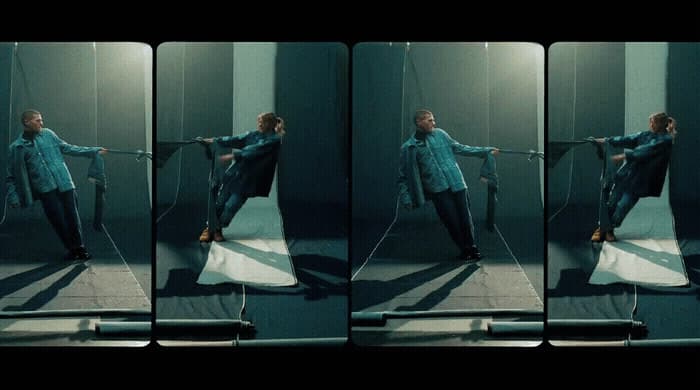 a woman in a blue shirt is holding a rope