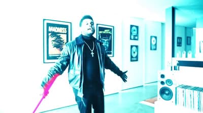 a man standing in a room holding a pink object