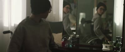 a man standing in front of a mirror in a room