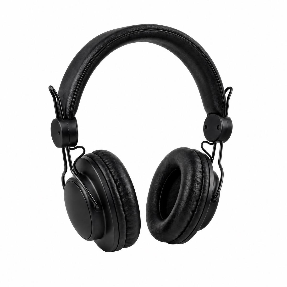 Headphones staged on a wooden desk next to a notebook and a mug - After