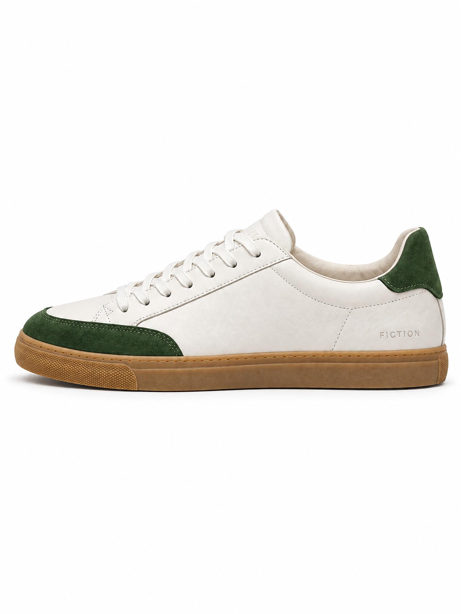 White sneaker with green suede panels on a hallway floor next to a doormat and a shoe rack, and the same sneaker in side profile on white - After