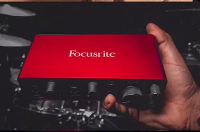 a person holding a red box with the word focusrite on it
