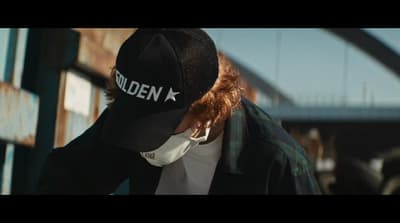 a man wearing a hat with the word hidden on it