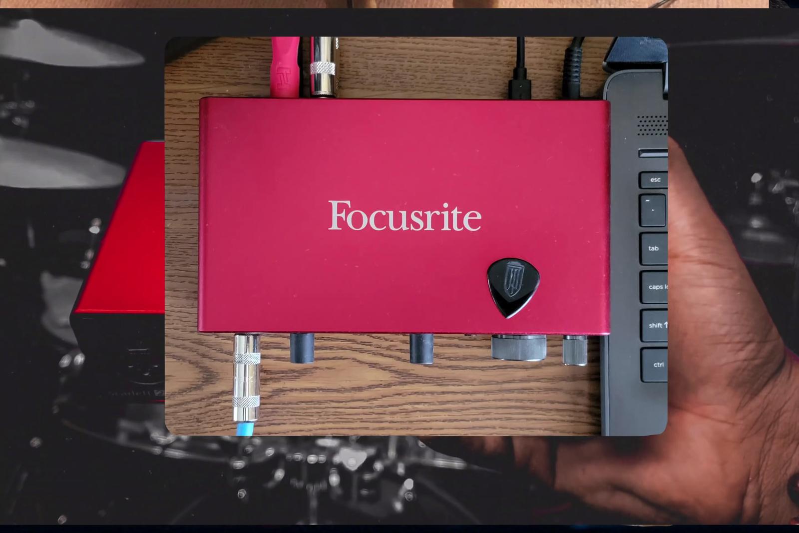 a person holding a red box with the word focusrite on it