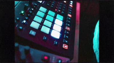 a close up of a keyboard with a person in the background