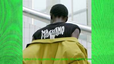 a man in a black shirt and yellow pants