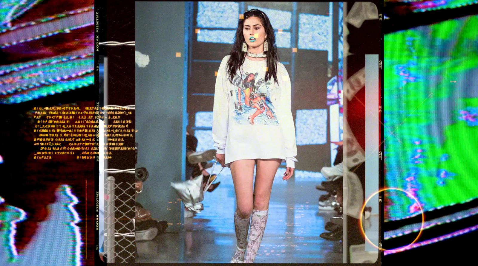 a woman walking down a runway in a white dress