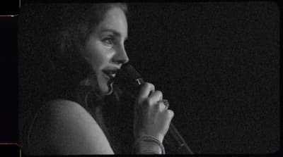 a woman holding a microphone up to her mouth