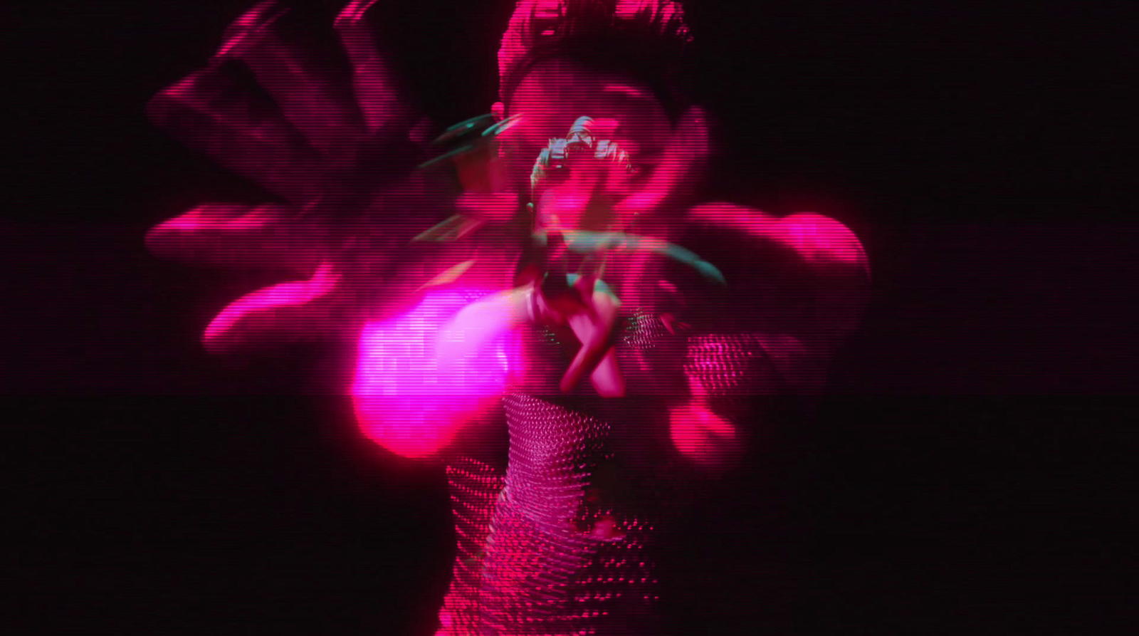 a blurry image of a woman in a pink dress