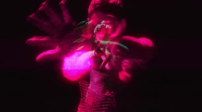 a blurry image of a woman in a pink dress