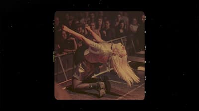 a woman is performing a trick in front of a crowd