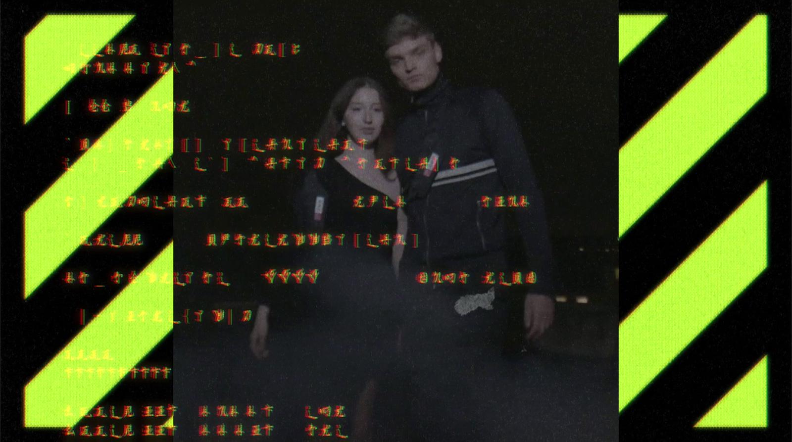a man and a woman standing in front of a computer screen