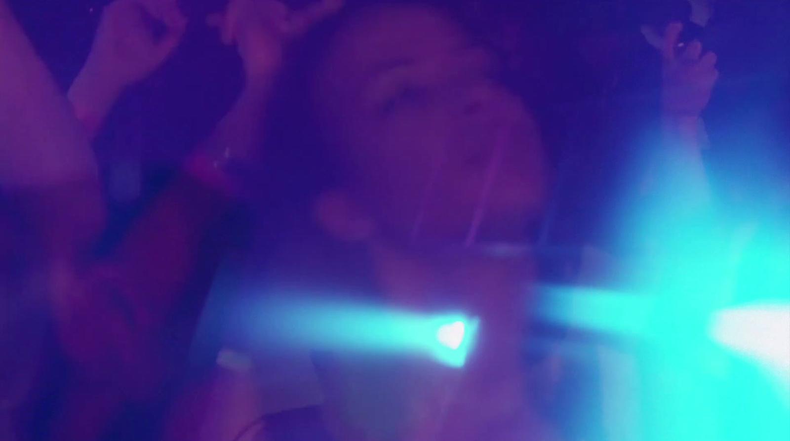 a woman singing into a microphone at a concert