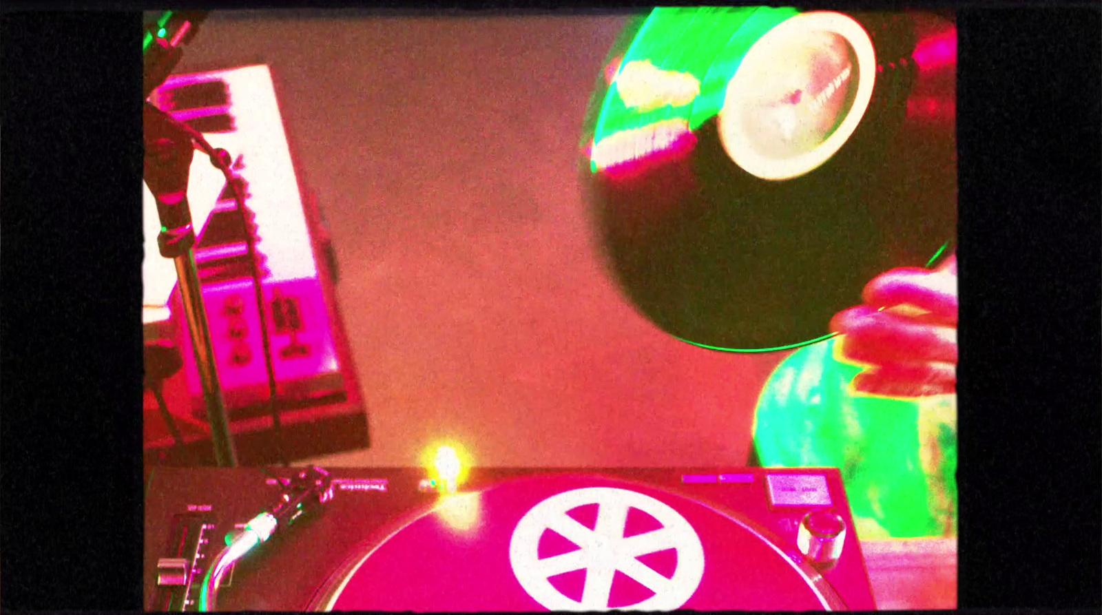 a turntable with a record player in the background