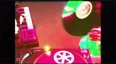 a turntable with a record player in the background