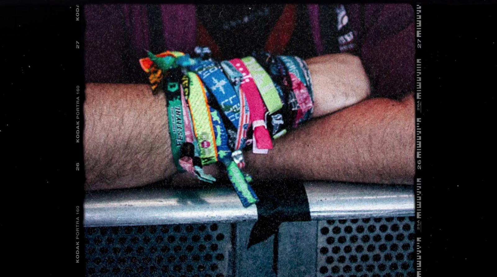 a man's arm with a bunch of bracelets on it