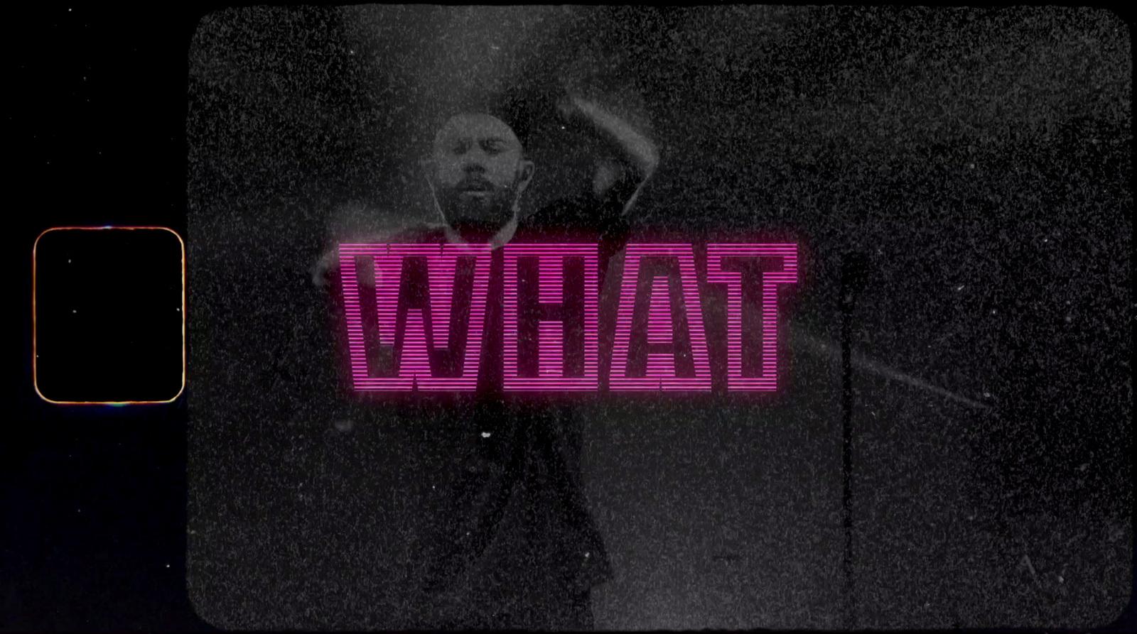 a man standing in front of a neon sign