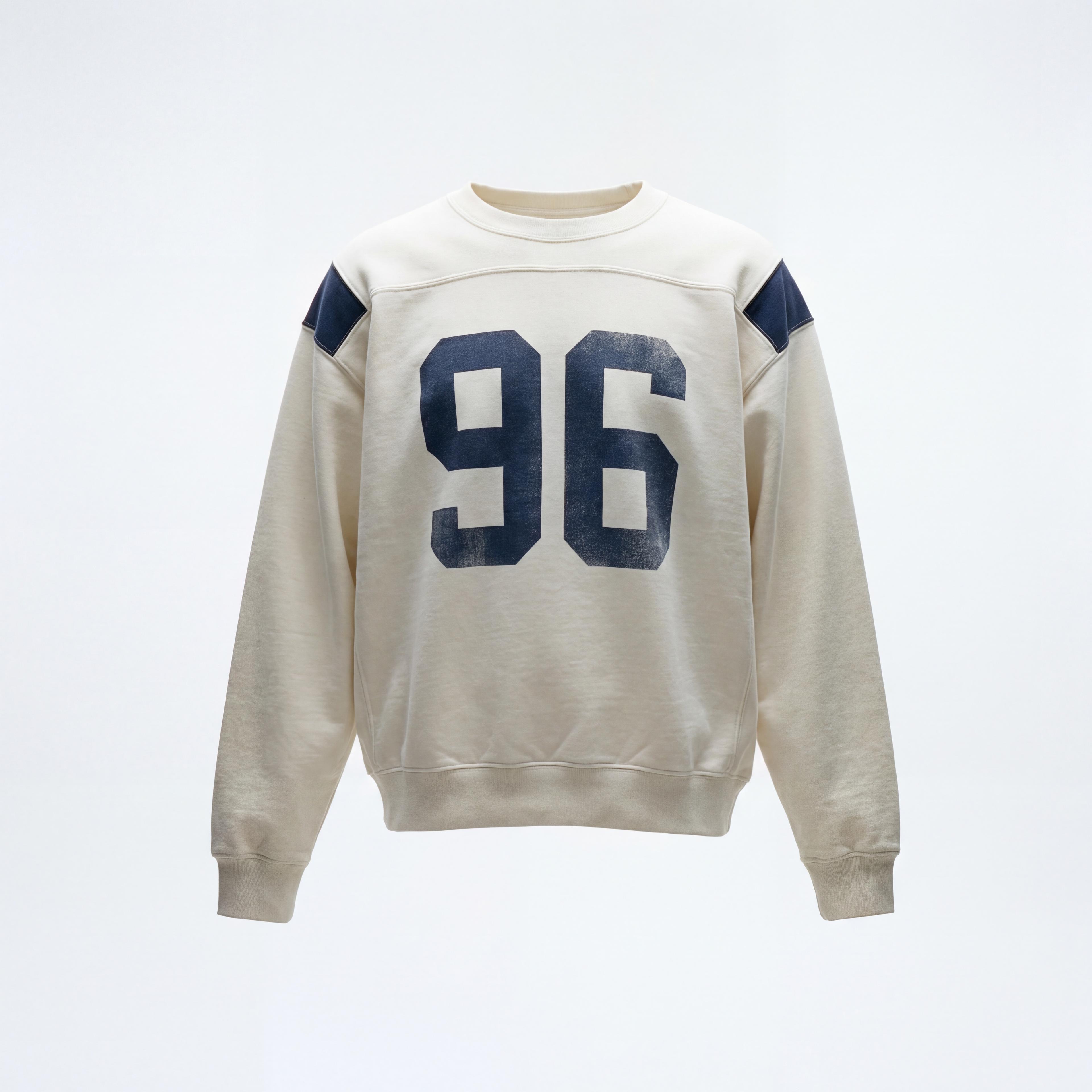 Cream sweatshirt with a navy number 96 laid flat, and the same sweatshirt worn by a young man in light blue jeans - Before