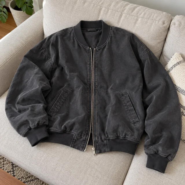 AI-generated home photo concept of a charcoal bomber jacket on a beige sofa